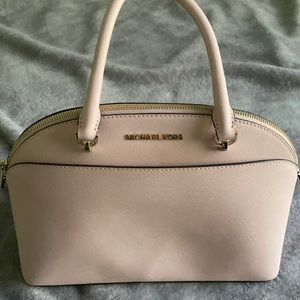 Never used Michael Kors purse. Light pink. Sturdy. Comes with cross body strap.